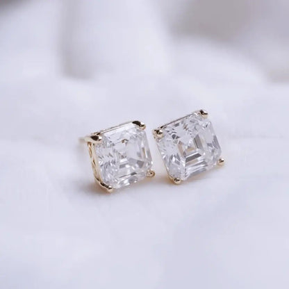 Pair of diamond stud earrings on a light background